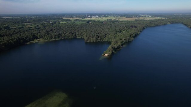 Aerial view of Dutch lake landscape with peninsula on bright early morning with woods in countryside making a picturesque scenery
