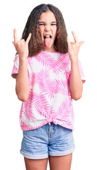 Cute hispanic child girl wearing casual clothes shouting with crazy expression doing rock symbol...
