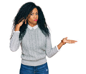 Middle age african american woman wearing casual clothes confused and annoyed with open palm showing copy space and pointing finger to forehead. think about it.