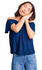 Fototapeta premium Young beautiful chinese girl wearing casual clothes sleeping tired dreaming and posing with hands together while smiling with closed eyes.