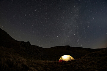 Fototapeta na wymiar A wild camping tent at night in Snowdonia Wales with stars and night sky