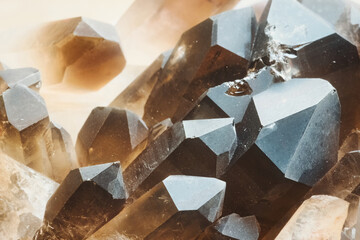 A close-up macro shot of a cluster of smokey quartz stones