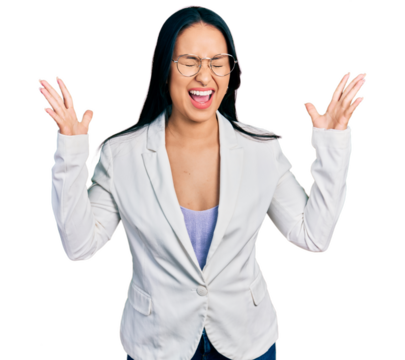 Beautiful hispanic woman with nose piercing wearing business jacket and glasses celebrating mad and crazy for success with arms raised and closed eyes screaming excited. winner concept