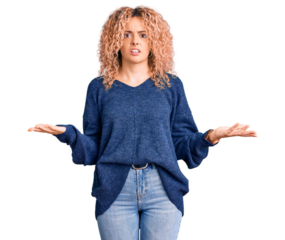 Young blonde woman with curly hair wearing casual winter sweater clueless and confused with open arms, no idea concept.