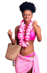 Young african american woman wearing bikini and hawaiian lei annoyed and frustrated shouting with...
