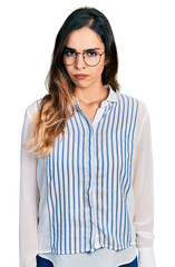 Beautiful hispanic woman wearing casual striped shirt skeptic and nervous, frowning upset because of problem. negative person.