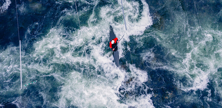 Top view boat of kayaker on mountain rough blue river, extreme sport kayak, aerial drone photo
