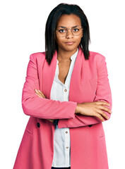 Beautiful hispanic woman wearing business jacket skeptic and nervous, disapproving expression on face with crossed arms. negative person.