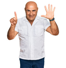 Mature middle east man with mustache wearing casual white shirt showing and pointing up with fingers number six while smiling confident and happy.