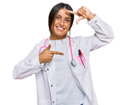 Beautiful hispanic woman wearing doctor uniform and stethoscope smiling making frame with hands and fingers with happy face. creativity and photography concept. - Powered by Adobe