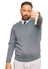 Handsome middle age man wearing business clothes looking unhappy and angry showing rejection and...