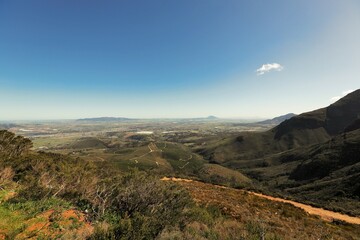 A view from Du Toits Kloof Pass towards Wellington in the distance on a hazy day.