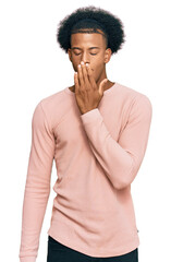 African american man with afro hair wearing casual clothes bored yawning tired covering mouth with hand. restless and sleepiness.