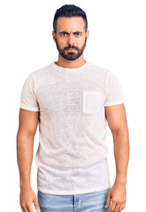 Young hispanic man wearing casual clothes skeptic and nervous, frowning upset because of problem. negative person.