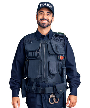 Young hispanic man wearing police uniform with a happy and cool smile on face. lucky person.