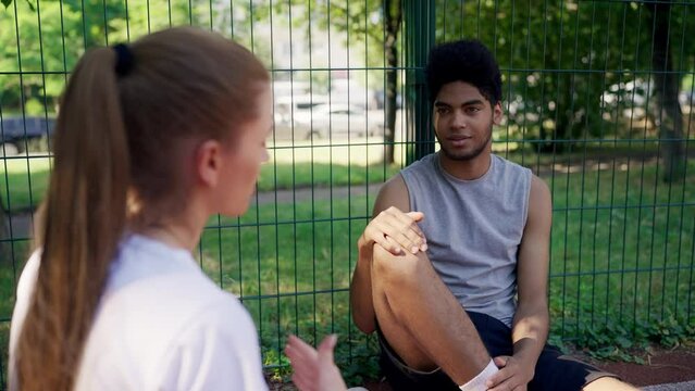 African American guy talking with female friend after training, sporty youth