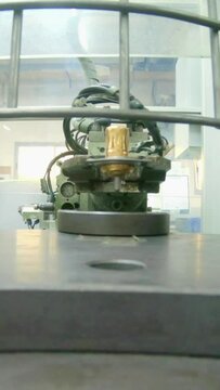 Vertical video of Advanced robotic machine manufacturing parts in an automated assembly line
