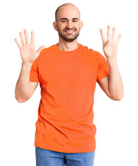 Young handsome man wering casual t shirt showing and pointing up with fingers number nine while smiling confident and happy.