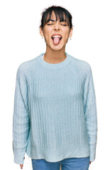 Young hispanic woman wearing casual clothes sticking tongue out happy with funny expression. emotion concept.