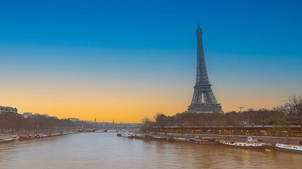 Fototapeta na wymiar The Eiffel Tower, iconic Paris landmark as autumn trees park as Seine river with sunset sky scene in Paris ,France