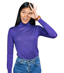 Beautiful young asian woman wearing casual clothes doing ok gesture with hand smiling, eye looking through fingers with happy face.