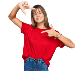 Teenager caucasian girl wearing casual red t shirt smiling making frame with hands and fingers with happy face. creativity and photography concept.