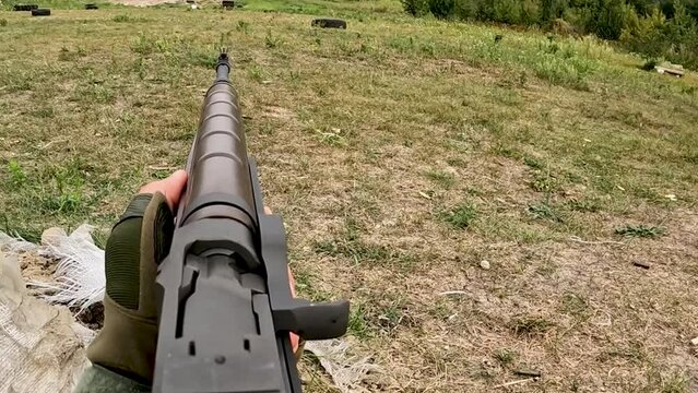 Poltava-Kharkiv region, Ukraine - August 2022: Ukrainian territorial defense fighter shoots from American M14 rifle. M14 rifle in the hands of a Ukrainian soldier.