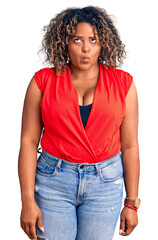 Young african american plus size woman wearing casual style with sleeveless shirt making fish face with lips, crazy and comical gesture. funny expression.