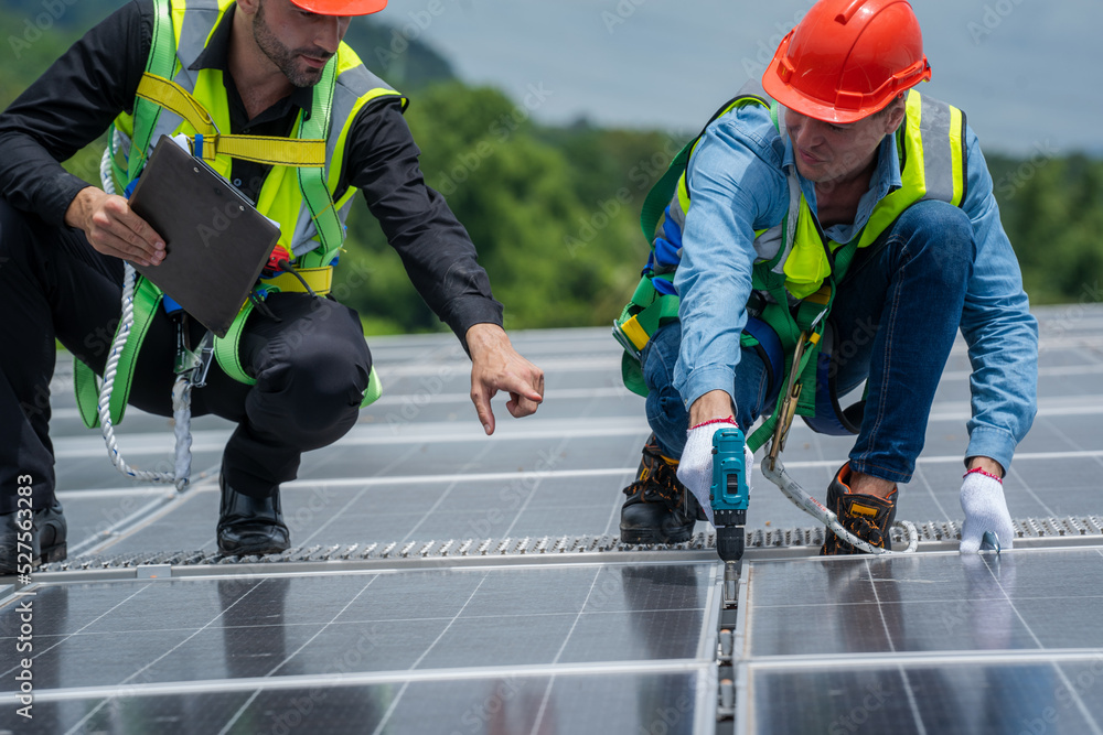 Poster solar power,engineer inspect solar panels on the roof of a factory where solar panels are installed 