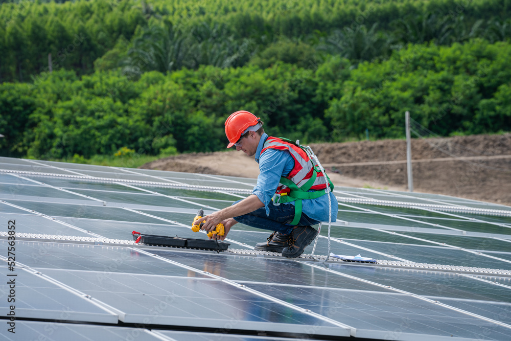 Poster solar power,engineer inspect solar panels on the roof of a factory where solar panels are installed 
