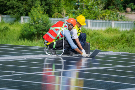 Solar panel energy,Electrical engineer man is working in solar station on roof using equipment,Alternative energy to conserve the world's energy.