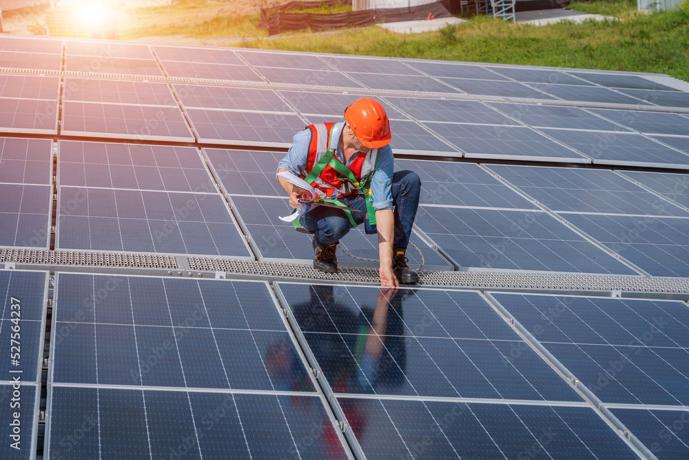 Poster engineer working and checking on solar panels on roof of factory,ecological,using natural renewable 