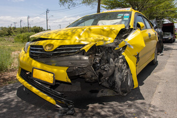 A taxi car damaged by a accident is stands on the street
