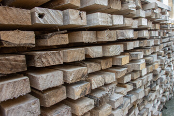 A pile of wooden planks ready for use on a construction site