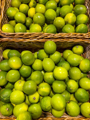 Fresh green lime fruits in basket  .Many lemons in supermarket 