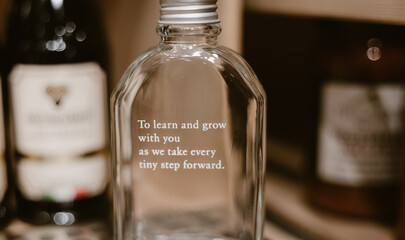a glass bottle with positive English words © Angie LAM