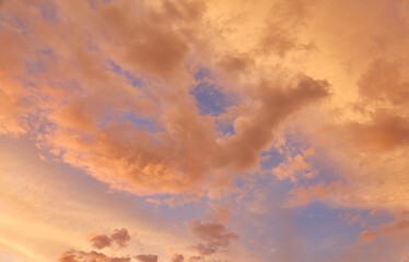 Clear blue sky. glowing pink and golden cirrus and cumulus clouds after storm, soft sunlight. Midnight sun. Dramatic sunset cloudscape. Meteorology, weather themes. Picturesque panoramic scenery