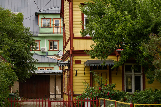 Backyard, wooden houses. Vintage rustic elements, balcony, terrace. Parnu, Estonia. City gardening, traditional architecture, real estate development, tourism concepts
