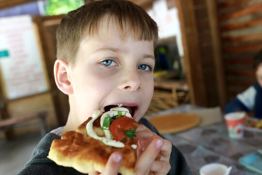Child eating adyghe pita bread