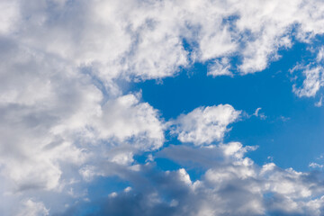 White and gray clouds in sun light on the blue sky perfect for the background. Landscape of beautiful blue sky with fluffy clouds
