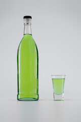 green colored alcohol absinth tincture or liquor with syrup, vodka, lime