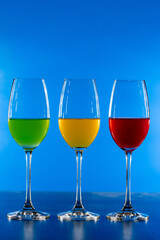 3 color drink in wine glass