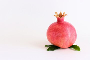 Rosh hashanah (jewish New Year holiday) concept. Pomegranate traditional symbol over white background