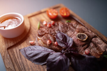 fresh lamb steak meat with berry sauce, tomato, rosemary, basil, pomegranate