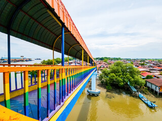 Rainbow bridge in Kuala Perlis. View of the colorful metal bridge extends across the fishing...