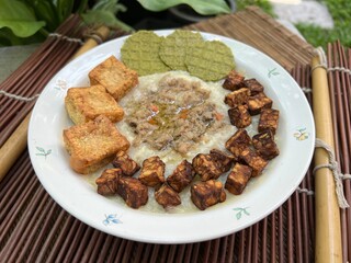 Congee with fried tempeh and stir pork and fried tofu