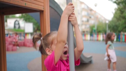 Child playing on playground warm summer day. Little girl have fun. Happy childhood. Caucasian little girl 5 years play outdoor