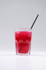 fresh cold fruit drink with red grape juice, ice, straw isolated