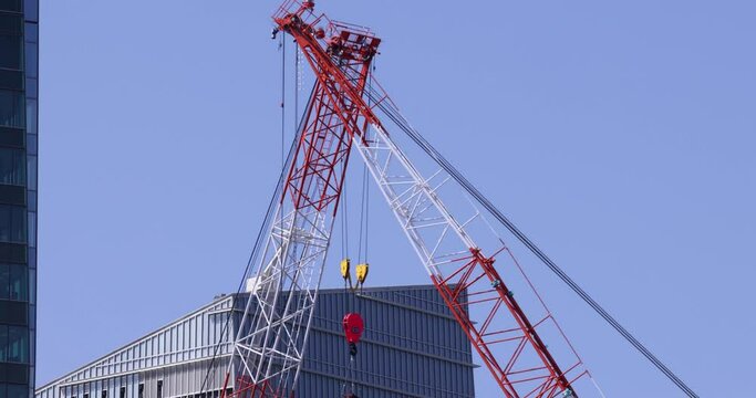 Moving cranes at the under construction daytime long shot