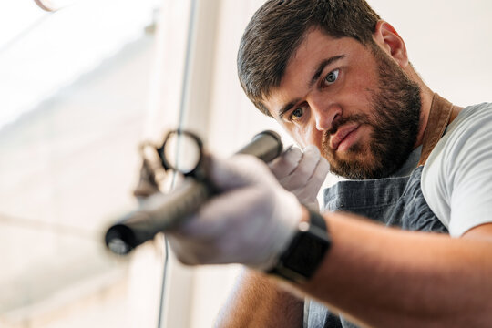 The gunsmith maintaining his rifle in a workshop